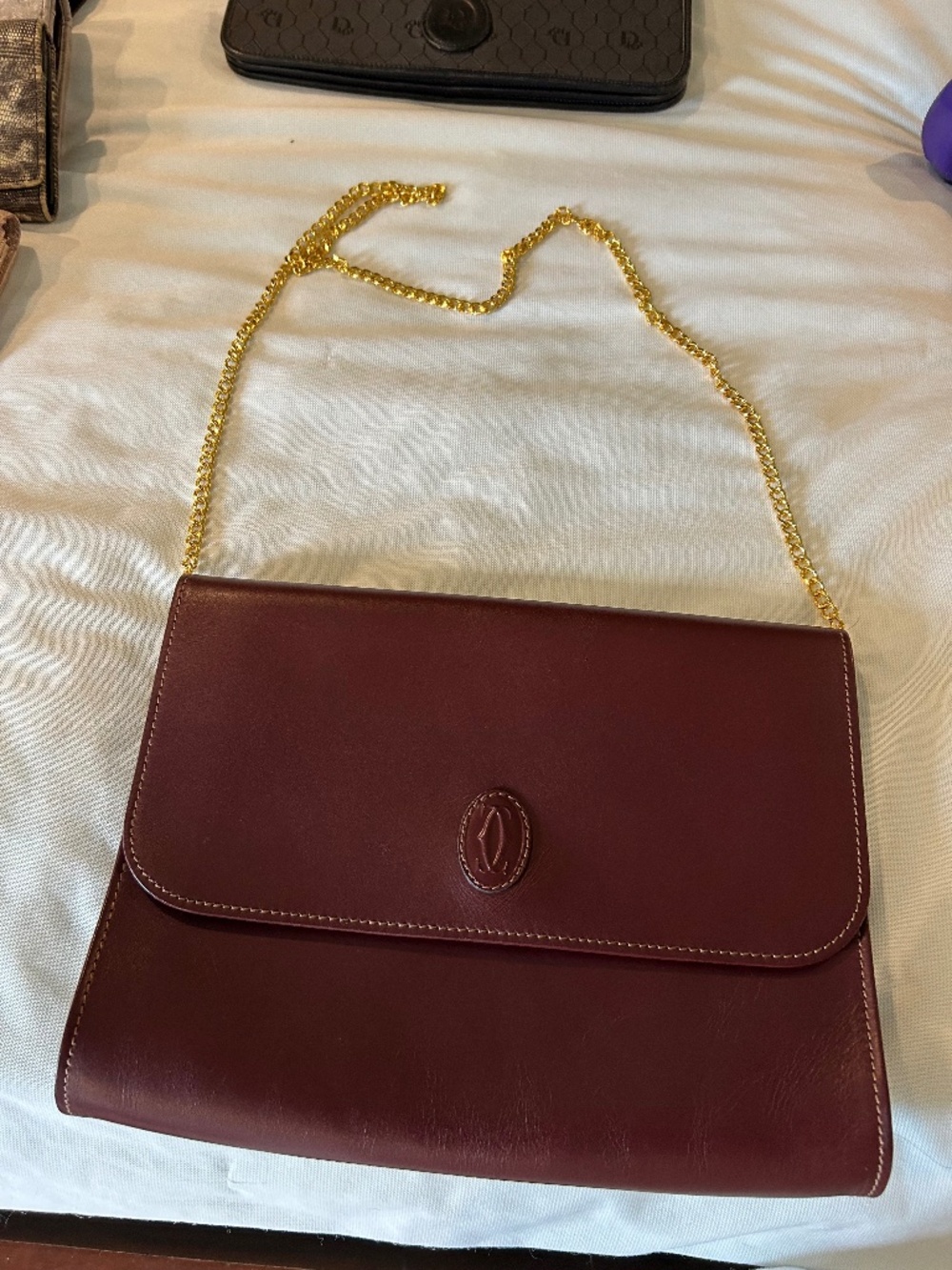 Cartier Leather Clutch. Beautiful, burgundy. New. Can be used as shoulder bag.